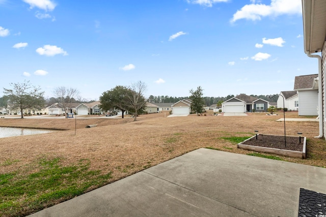 view of yard with a garage and a residential view