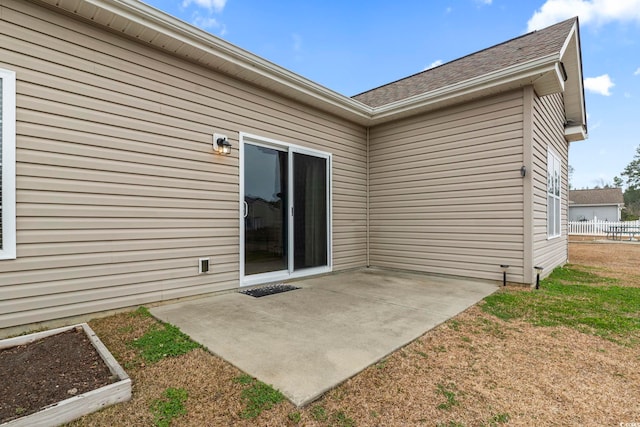 doorway to property featuring fence and a patio area