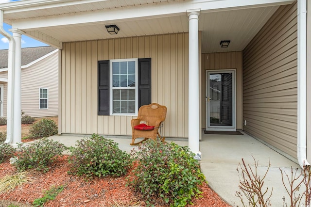 entrance to property with a porch and board and batten siding