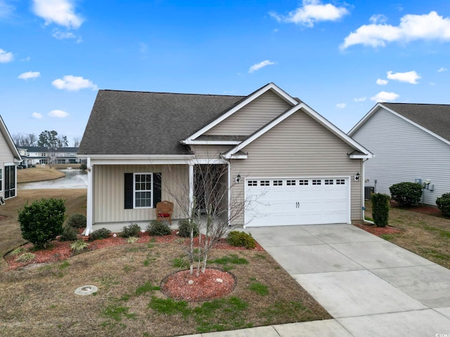 view of front of house with driveway, board and batten siding, an attached garage, and a shingled roof