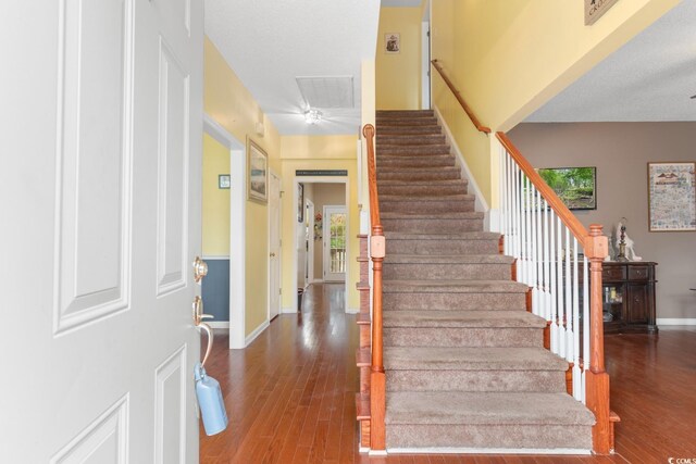 stairs with hardwood / wood-style floors