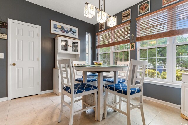 dining area with plenty of natural light and light tile patterned floors