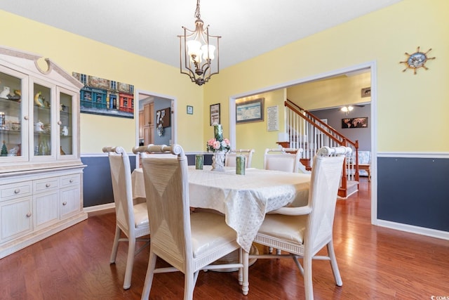 dining room featuring hardwood / wood-style flooring and a notable chandelier