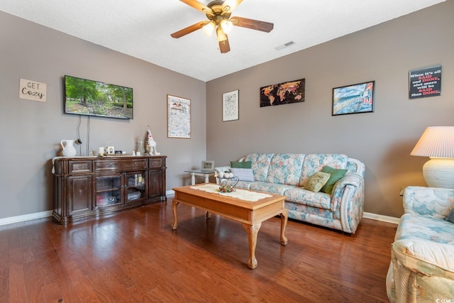 living room with ceiling fan and dark hardwood / wood-style flooring