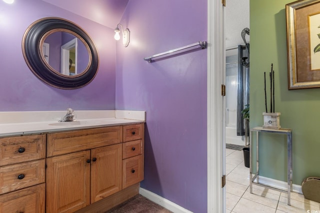 bathroom with vanity, vaulted ceiling, tile patterned floors, and a shower