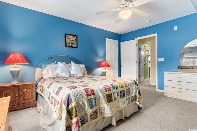 bedroom featuring ceiling fan and light carpet