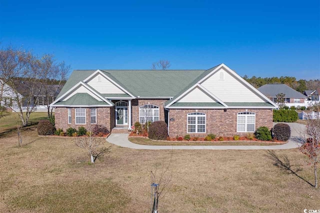 view of front of home with a front yard and brick siding