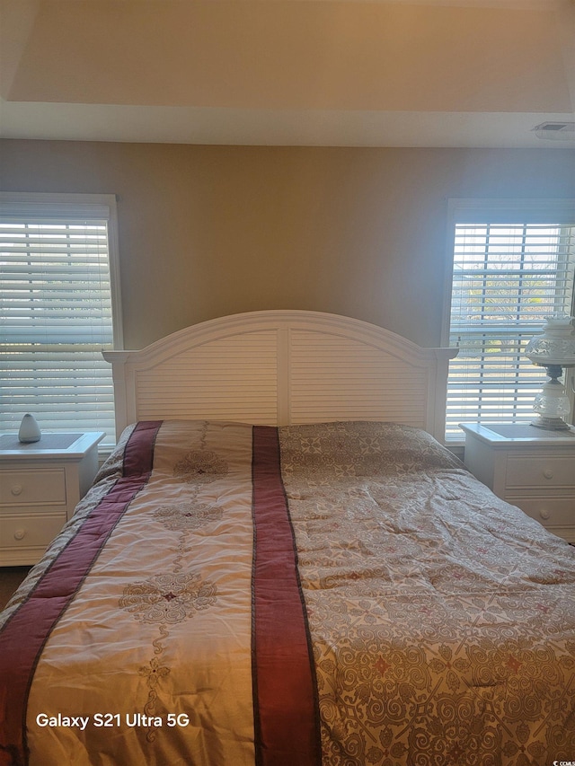 bedroom featuring multiple windows and visible vents