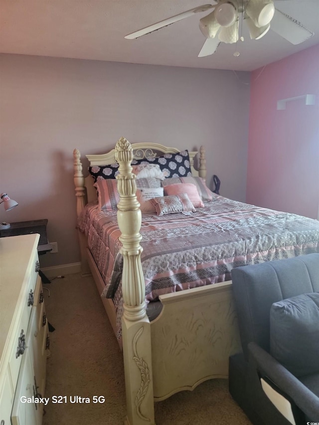 bedroom with light colored carpet, ceiling fan, and baseboards