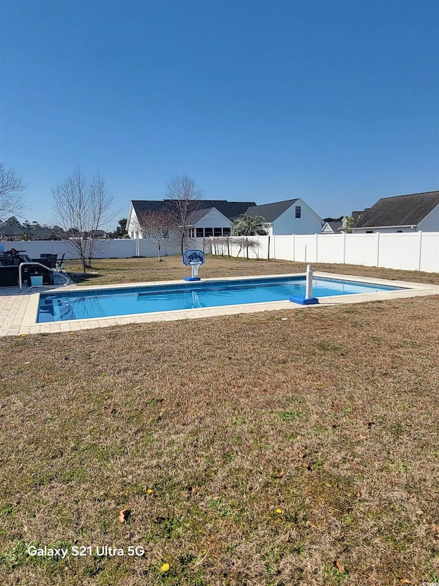 view of pool featuring a fenced in pool, a fenced backyard, and a lawn