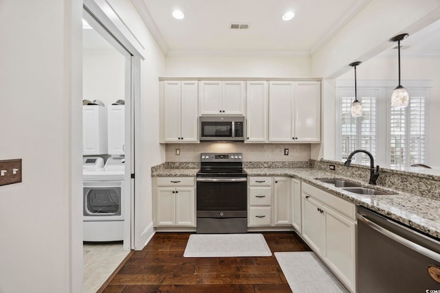1188 Peterson St, Myrtle Beach, SC 29577 - kitchen with stainless steel appliances, a sink, ornamental molding, dark wood-type flooring, and light stone counters