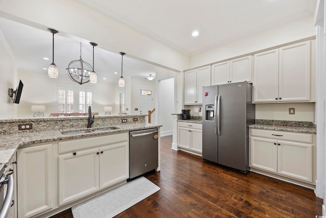 1188 Peterson St, Myrtle Beach, SC 29577 - kitchen with stainless steel appliances, a sink, a chandelier, light stone countertops, and hanging light fixtures