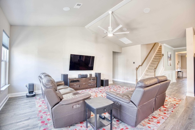 living room featuring ceiling fan, wood-type flooring, and vaulted ceiling with beams