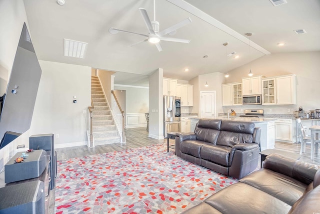 living room with ceiling fan, high vaulted ceiling, and light hardwood / wood-style floors