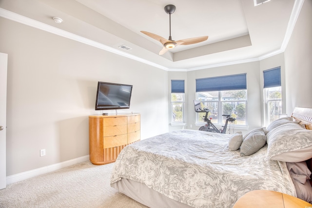 bedroom with crown molding, carpet flooring, a tray ceiling, and ceiling fan