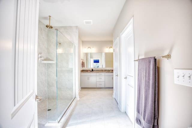 bathroom featuring vanity, tile patterned flooring, and walk in shower