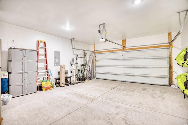 garage with a garage door opener and electric panel