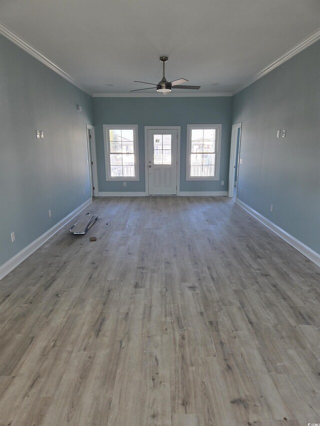 328 46th Ave N, North Myrtle Beach, SC 29582 - unfurnished living room with ceiling fan, baseboards, healthy amount of natural light, wood finished floors, and ornamental molding