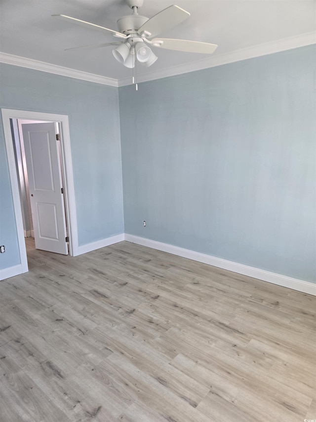 unfurnished room featuring ceiling fan, crown molding, baseboards, and wood finished floors