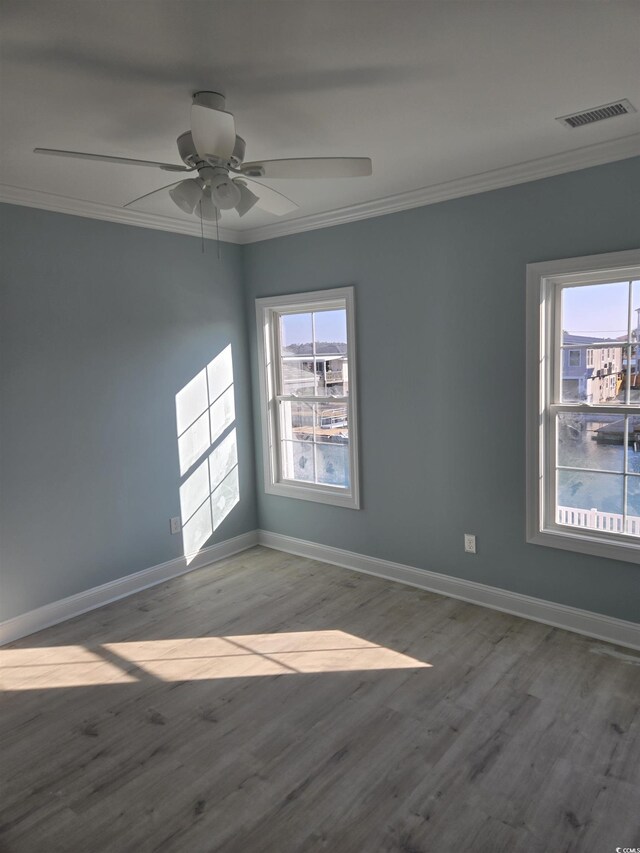 328 46th Ave N, North Myrtle Beach, SC 29582 - empty room featuring crown molding, wood finished floors, baseboards, and a ceiling fan
