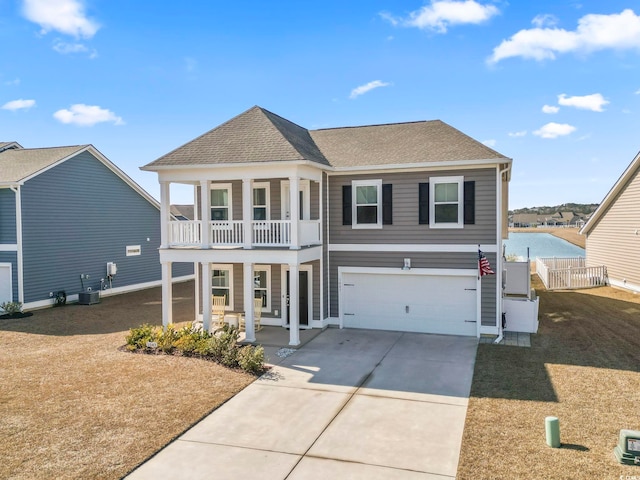 view of front of house featuring a garage, a balcony, and a porch