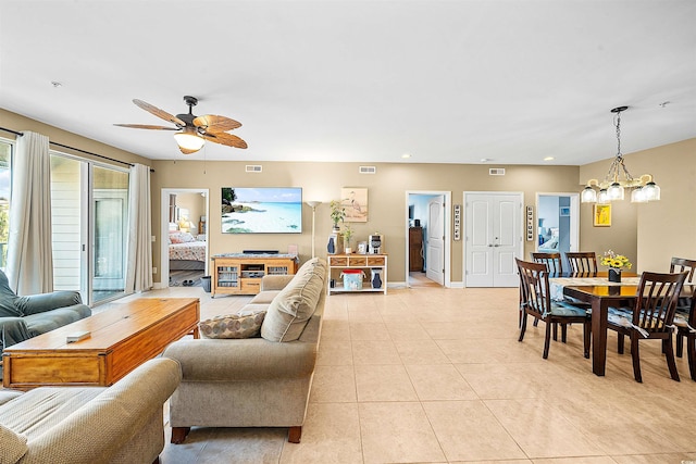 living room featuring recessed lighting, visible vents, ceiling fan with notable chandelier, and light tile patterned flooring