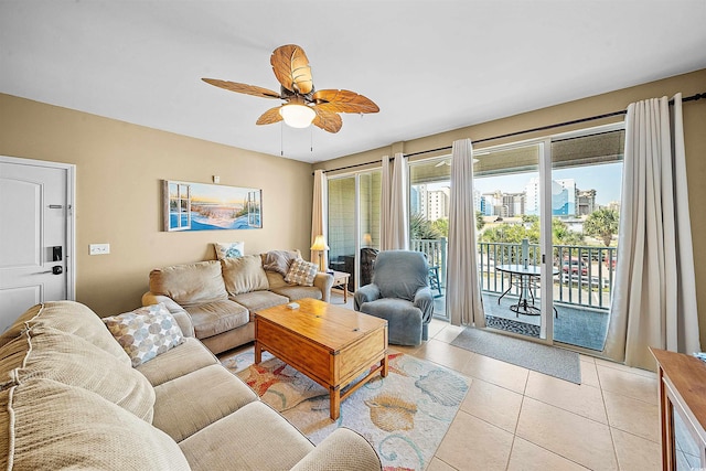 living area with a city view, ceiling fan, and light tile patterned floors