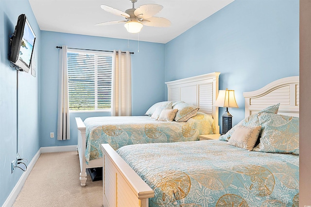 bedroom featuring light carpet, ceiling fan, and baseboards