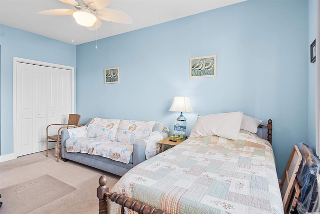 bedroom featuring a ceiling fan, carpet, a closet, and baseboards