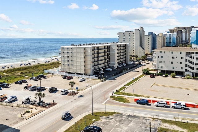 drone / aerial view featuring a water view, a view of city, and a view of the beach