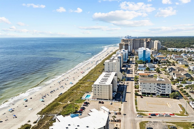 drone / aerial view with a water view, a city view, and a view of the beach