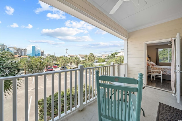 balcony featuring a city view and ceiling fan