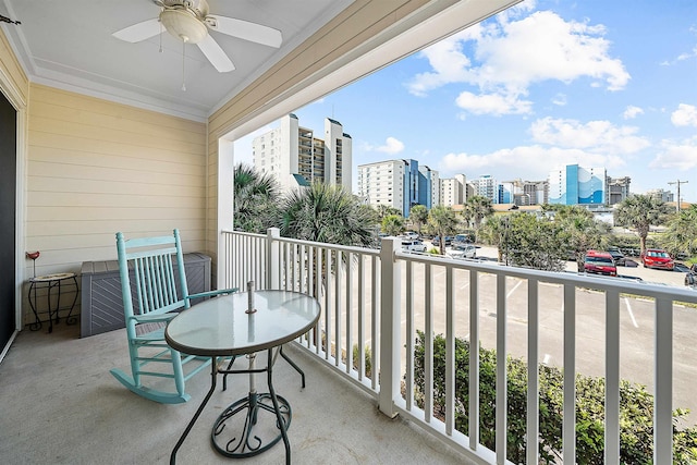 balcony with a ceiling fan and a city view