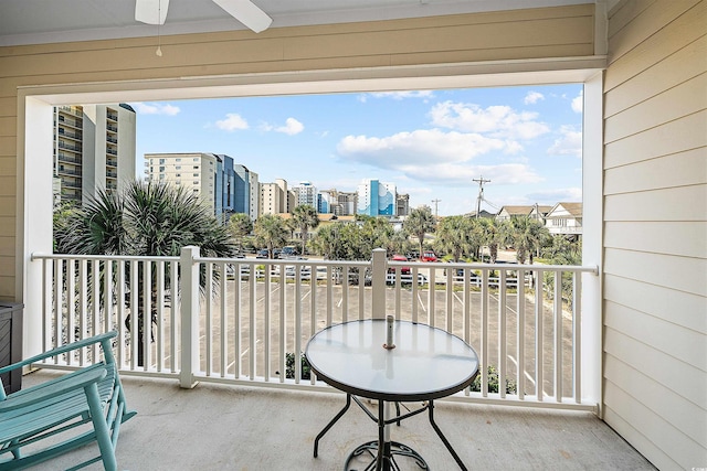 balcony featuring ceiling fan and a view of city