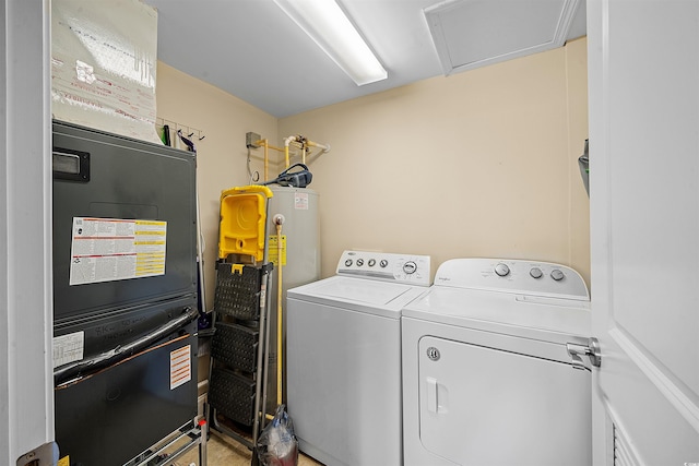 laundry area featuring heating unit, laundry area, washing machine and dryer, and attic access