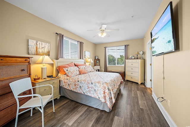 bedroom featuring dark wood-style floors, baseboards, and a ceiling fan