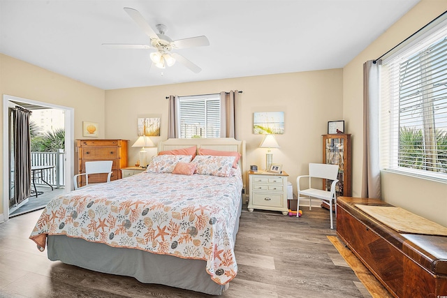 bedroom with access to outside, a ceiling fan, and dark wood-style flooring