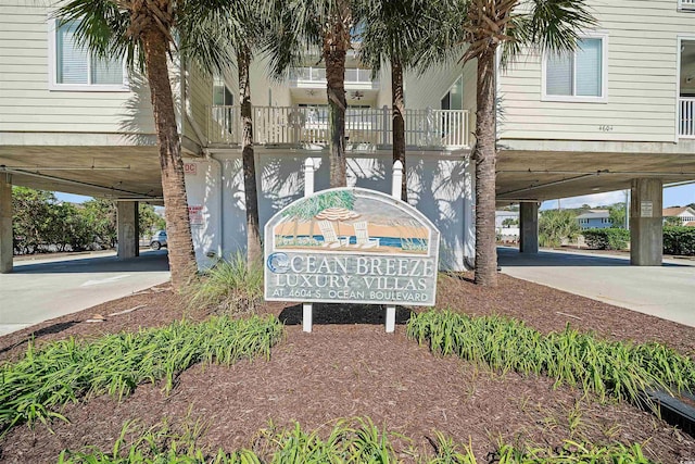 community sign with a carport and concrete driveway