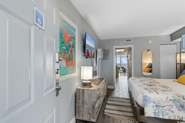 bedroom featuring baseboards and visible vents