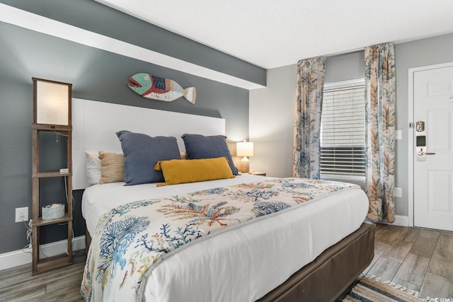 bedroom with wood finished floors and baseboards