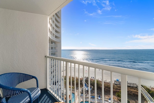 balcony with a beach view and a water view