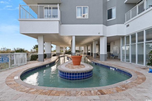 view of pool with a patio area and fence