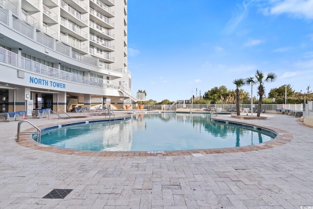 pool featuring a patio and fence