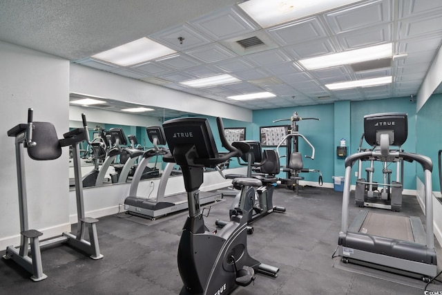 exercise room featuring visible vents and baseboards