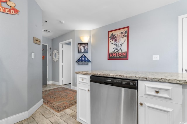 kitchen featuring white cabinetry, dishwasher, and light stone countertops