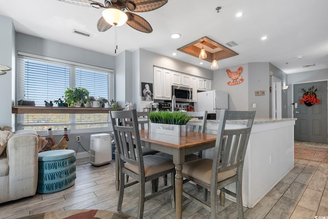 dining area with wood tiled floor, visible vents, and recessed lighting