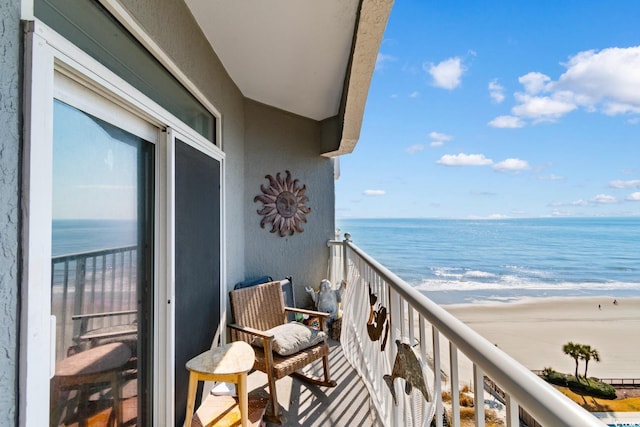 balcony with a water view and a beach view