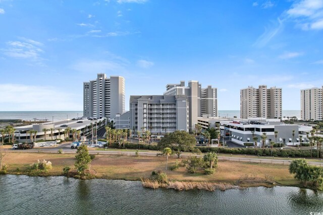 drone / aerial view featuring a water view and a beach view