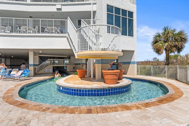 view of swimming pool with fence, a patio, and stairs