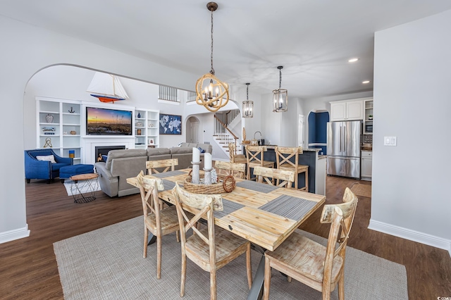 dining space featuring dark hardwood / wood-style flooring and an inviting chandelier